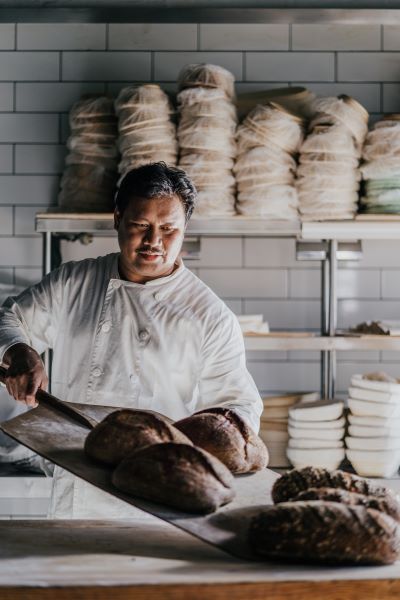 Roderick Obrero baking bread in the Bake House for Lake House restaurants' and cafes